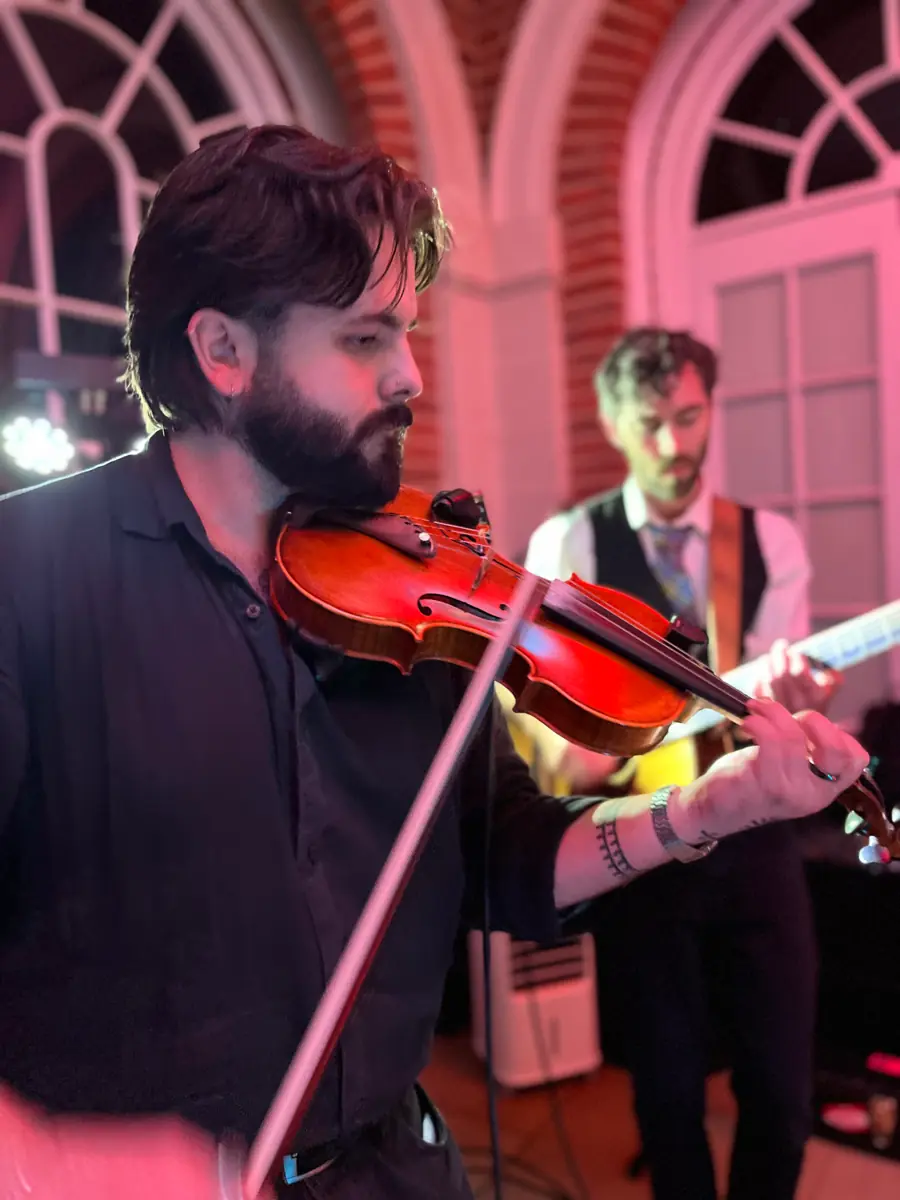Fiddle player under pink stage lights