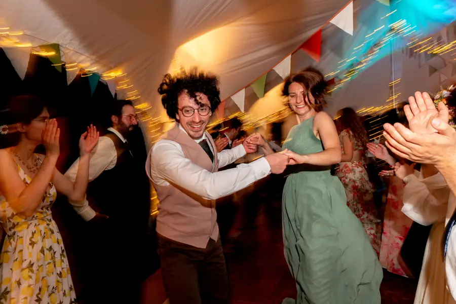 Wedding couple mid-dance under bunting